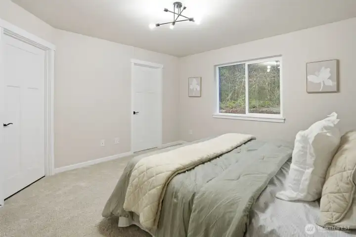 Generous primary suite offering comfort, natural light, and convenient ensuite access