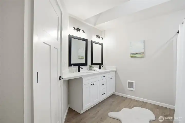 Primary bath with dual sinks and modern finishes