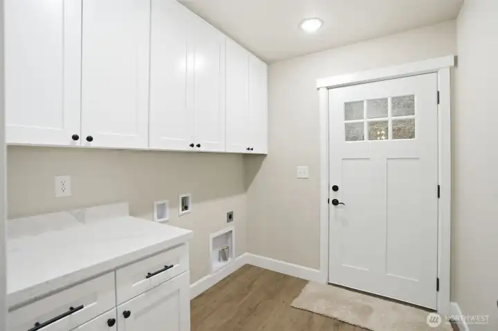Dedicated laundry room with added storage and sound dampening insulation