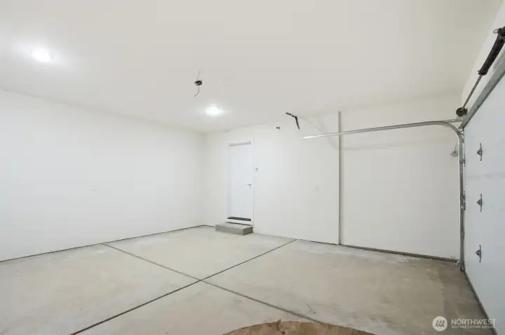 Spacious garage featuring 400 sq ft of versatile space and convenient garage door opener