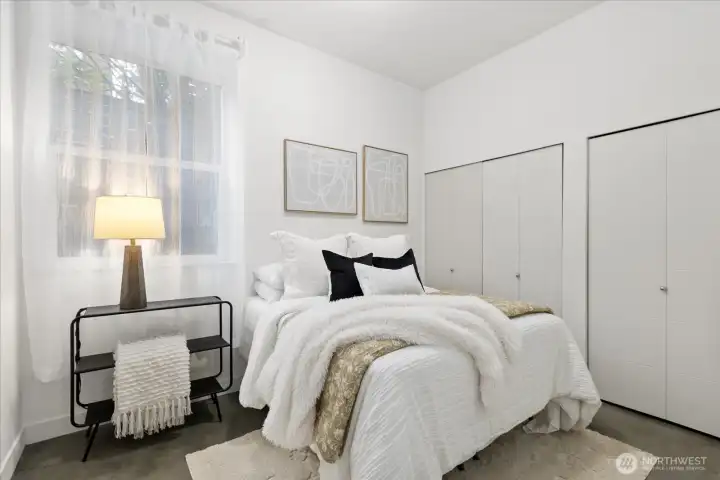Bedroom #1 on first floor. Appreciate the extra tall ceilings and large window with an abundance of natural light.  Perfect potential space for roommate, guests, 2nd office or gym.