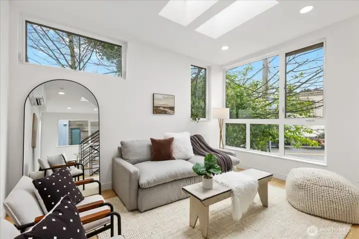 Third floor lives like a modern tree house perched in the trees, beaming with natural light. Appreciate the large windows and skylights.
