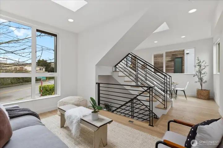 Third floor living room opens into the dining space off the kitchen.