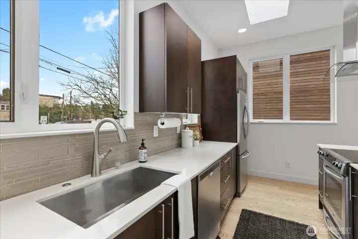 Cleaning dishes done right with the large window offering territorial views.