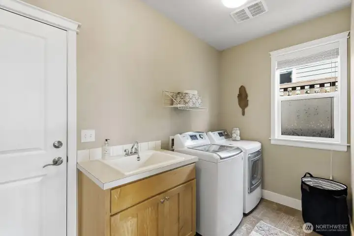 Main floor Utility Room with storage and garage door