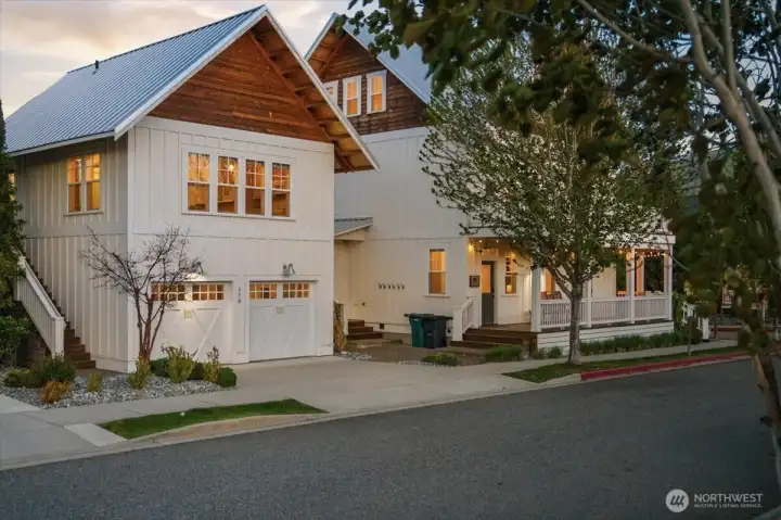Exterior twilight view of main home and detached 2-car garage with 594sf 1bd/1bth and living room carriage house above.