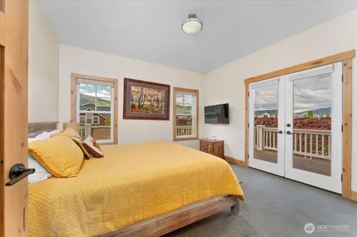 Upper level west facing Primary Bedroom with French doors leading to the lake and park view deck.