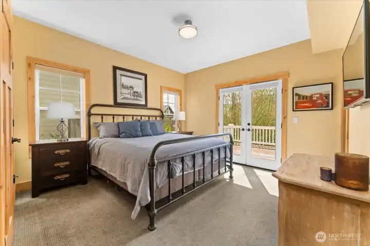 Upper level south facing Primary Bedroom with King sized bed and attached ensuite bathroom.