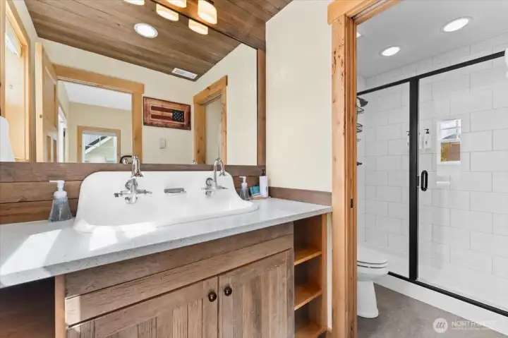 Upper level south facing Primary Bedroom bathroom with farmhouse sink and vintage barn wood accents.
