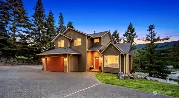 Warm evening glow highlights the home’s inviting character. Warm evening glow highlights the home’s inviting character.