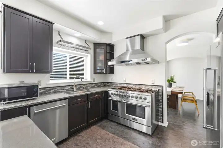 The gourmet kitchen is complemented by professional-grade appliances, custom cabinetry, and granite countertops. The gourmet kitchen is complemented by professional-grade appliances, custom cabinetry, and granite countertops.