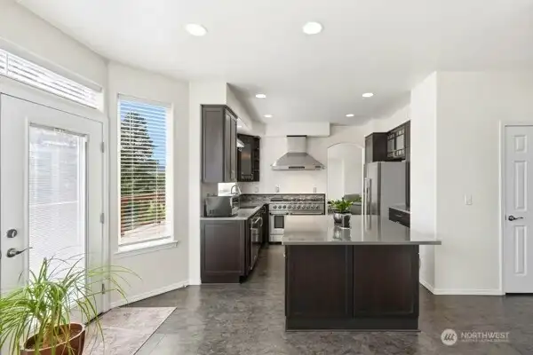 A door just off the kitchen leads to the full-length deck, ideal for outdoor meals, gatherings, or morning coffee. A door just off the kitchen leads to the full-length deck, ideal for outdoor meals, gatherings, or morning coffee.