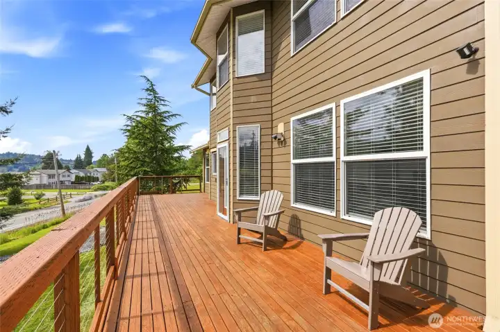 Spanning the full length of the home, the deck is an inviting space for outdoor dining, entertaining, or relaxing in the fresh air. Spanning the full length of the home, the deck is an inviting space for outdoor dining, entertaining, or relaxing in the fresh air.