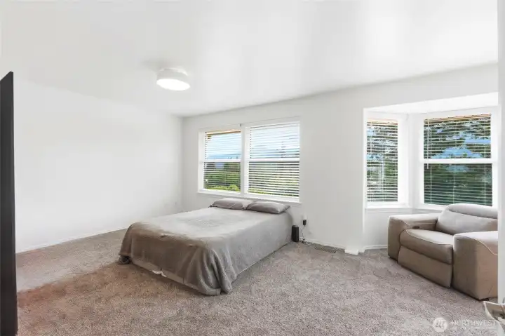 The spacious primary suite is a peaceful retreat complete with a walk-in closet and private ensuite bath. The spacious primary suite is a peaceful retreat complete with a walk-in closet and private ensuite bath.