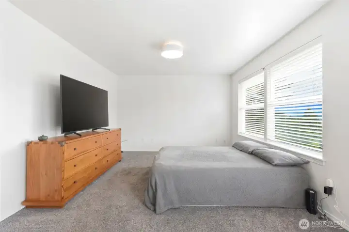 Generously sized bedroom with large windows and views of the surrounding area. Generously sized bedroom with large windows and views of the surrounding area.