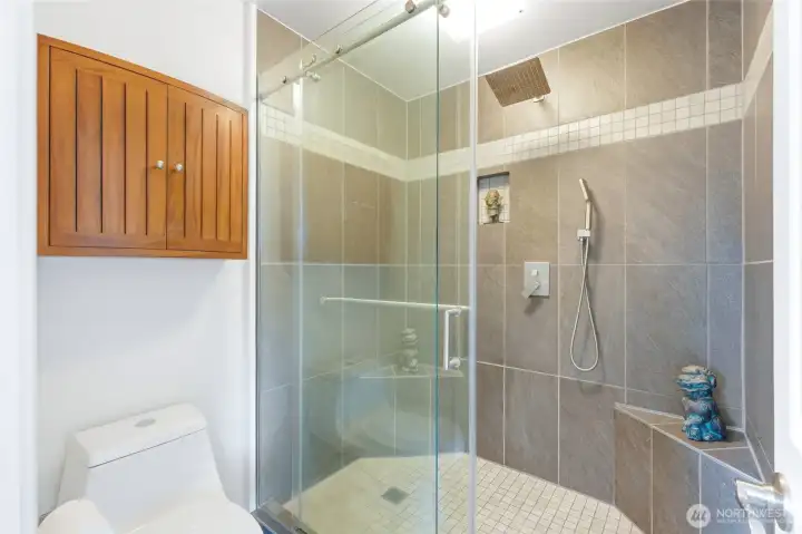 The beautifully updated ensuite bath features a custom walk-in tile shower. The beautifully updated ensuite bath features a custom walk-in tile shower.