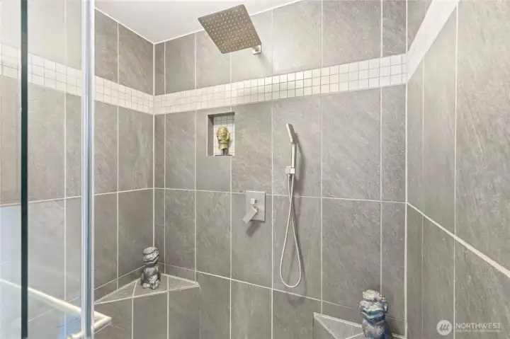A custom tile shower is the highlight of the primary ensuite bath. A custom tile shower is the highlight of the primary ensuite bath.