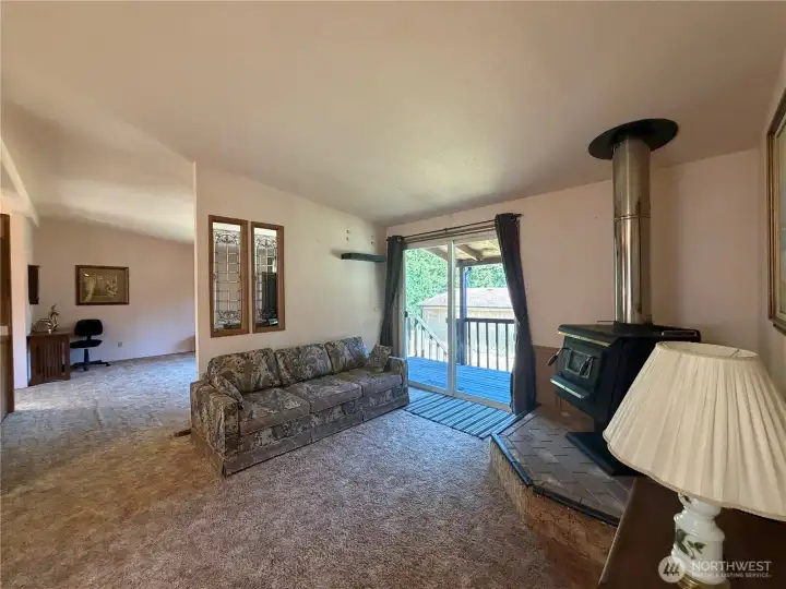 Living room with deck access. Family room in the background. Living room with deck access. Family room in the background.