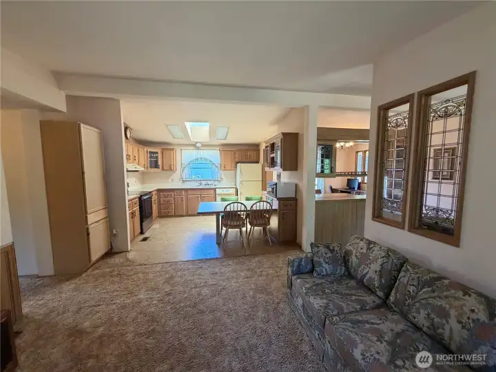 Living room with kitchen in background. Living room with kitchen in background.