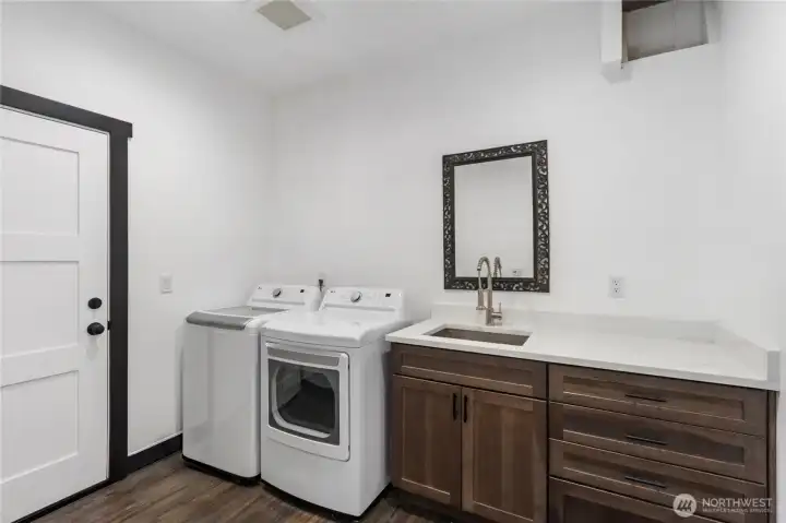 Laundry Room complete with Sink, Cabinets, and Folding Counter Laundry Room complete with Sink, Cabinets, and Folding Counter