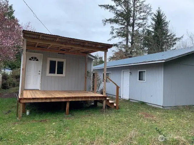 The new covered porch at the rear of the house and the entrance to the bunkroom and bathroom behind the garage.