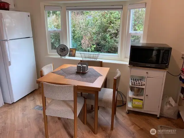 Sunny dining area in the kitchen under the large window.