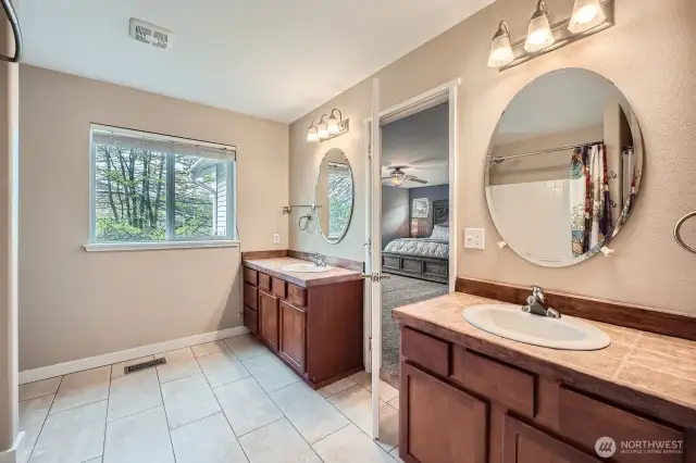 Master Suite bathroom with two vanities and mirrors large window