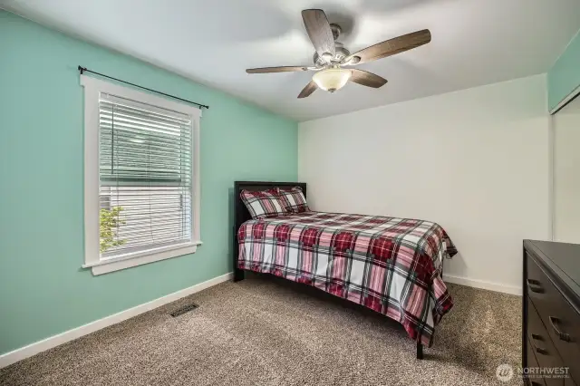 Second floor room with double sliding mirror doors and a ceiling fan