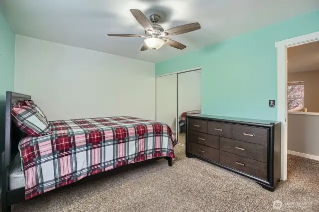 Second floor bedroom door opens to hallway to loft and other bedrooms