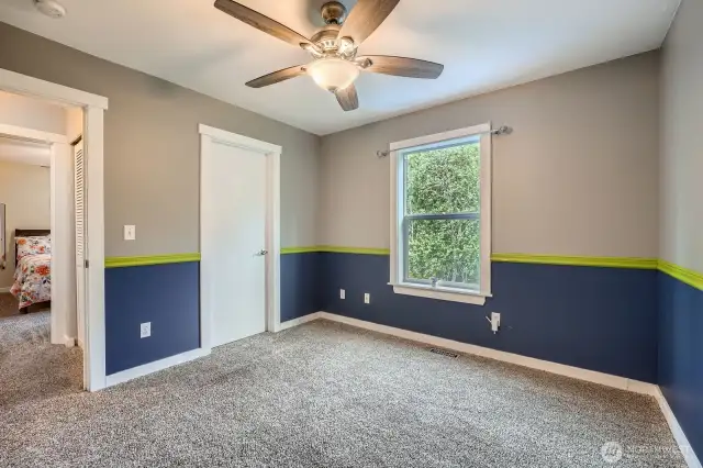 Second floor bedroom with door opening into hallway across from additional bedroom with large linen closet betweeen the two bedrooms