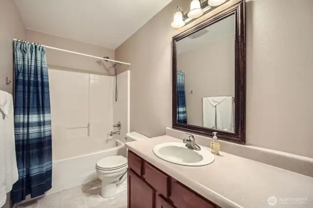 Bathroom upstairs with vanity and shower large and large mirror