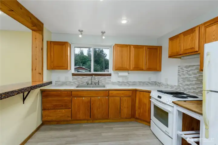 The window above the sink brings in natural light, creating an inviting workspace that blends both charm and functionality.