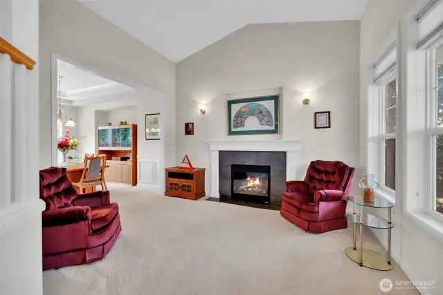 The living room is comfy and cozy.  High vaulted ceilings and gas fireplace make a great focal point.  The front window blinds go from sheer to block out blinds depending on your level of privacy. The living room flows into the dining room making a great entertainment space.