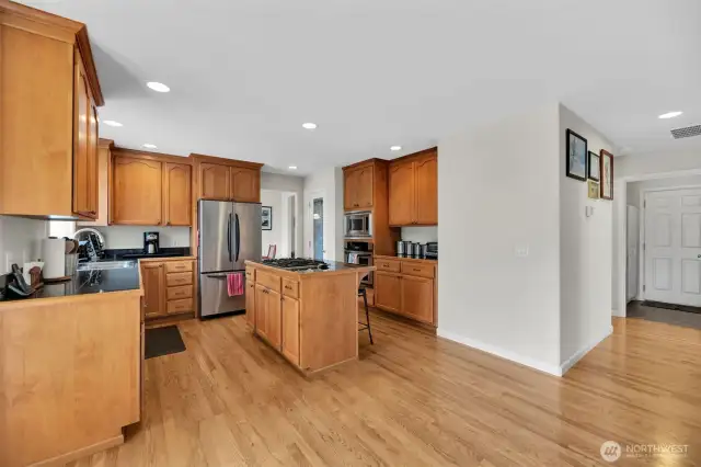 Circular floor plan gives this home a great flow. The door to the right leads to the attached 3 car garage.  Real oak hardwoods are easy to keep shiny and clean and add a touch of elegance.