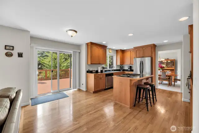 Large sliding glass door leads to spacious rear deck and fenced back yard with Blueberries and Cherries. Dining room is to the right and family room is to the left.
