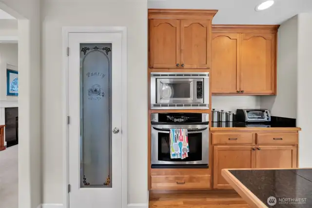 Step in pantry for additional storage next to the oven and built in microwave.