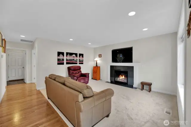 Family room with high ceilings and recessed lighting. Gas fireplace makes a great focal point and the TV fits so well, its included for your convenience! The office space door is on the left of this photo just to the right before the laundry room and garage door.