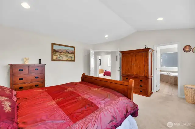 Double french doors as you enter the primary bedroom with vaulted ceilings. To the right is the 5 piece primary bath.