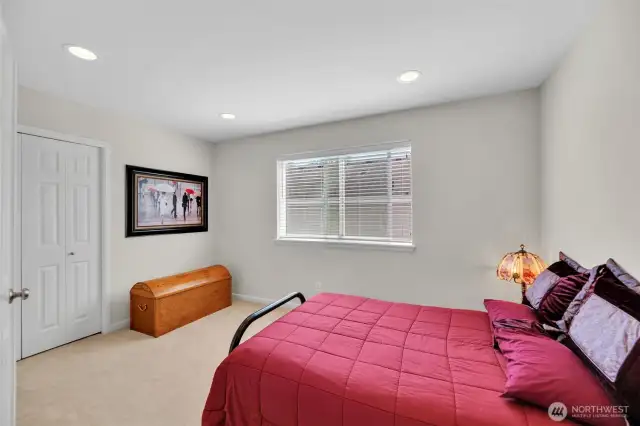 Bedroom 2 with high ceilings and french doors.