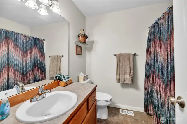 The guest bath is convenient to the bedrooms.