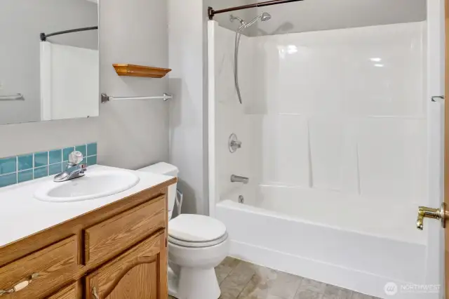 Full bath with tub/shower combination.