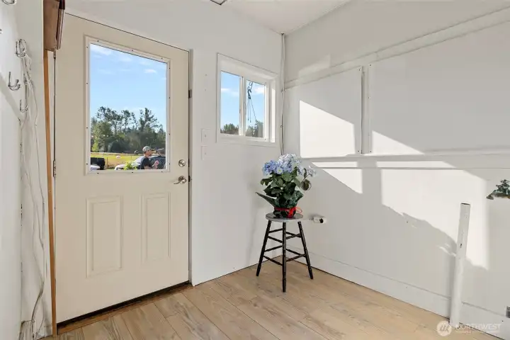 Laundry area just inside the back door - very practical for coming in front work or play.