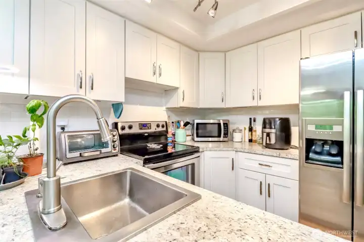 Enjoy cooking with stainless steel appliances and soft close drawers