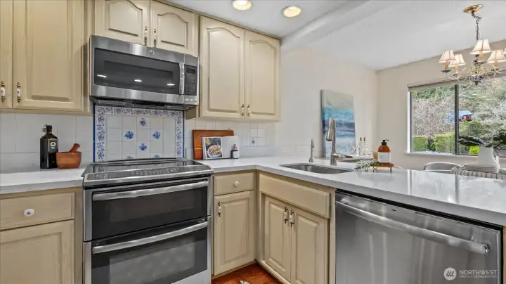 Stainless appliances and an induction stove-top range.