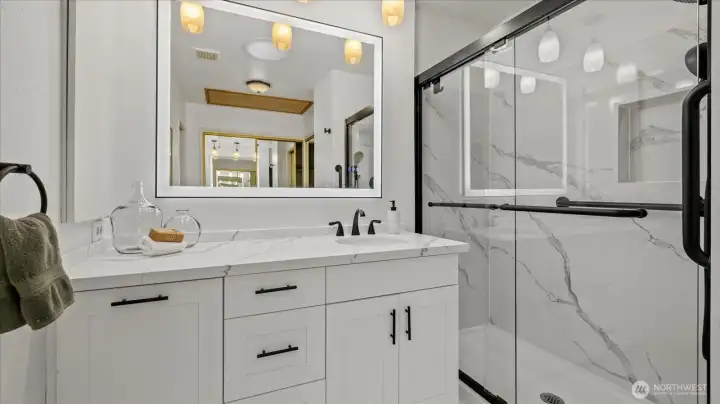 Programable vanity mirror. Quartz counters and marble flooring.