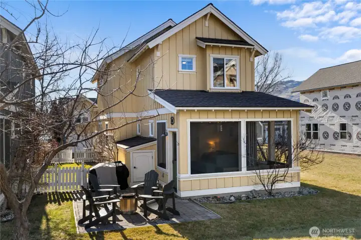 Screened veranda looks out at common greenspace.
