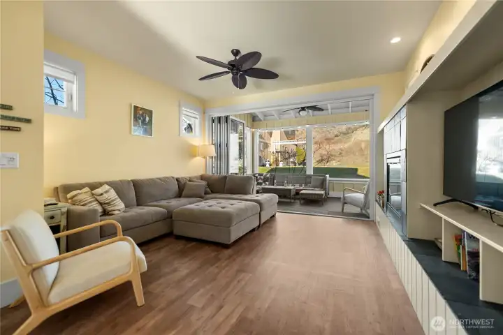 Main level great room offers vinyl plank floors.  Glass Nano doors that open fully to the back Veranda.