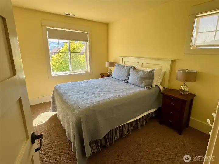 Guest Bedroom looks out at Lake.    Queen bed,  this 3 bedroom cottage comfortably sleeps 8