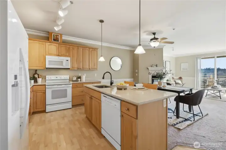 Spacious kitchen with breakfast bar and open sightlines to living and dining areas