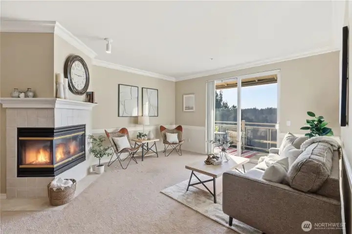 Light-filled living area with comfortable open-concept layout and cozy gas fireplace